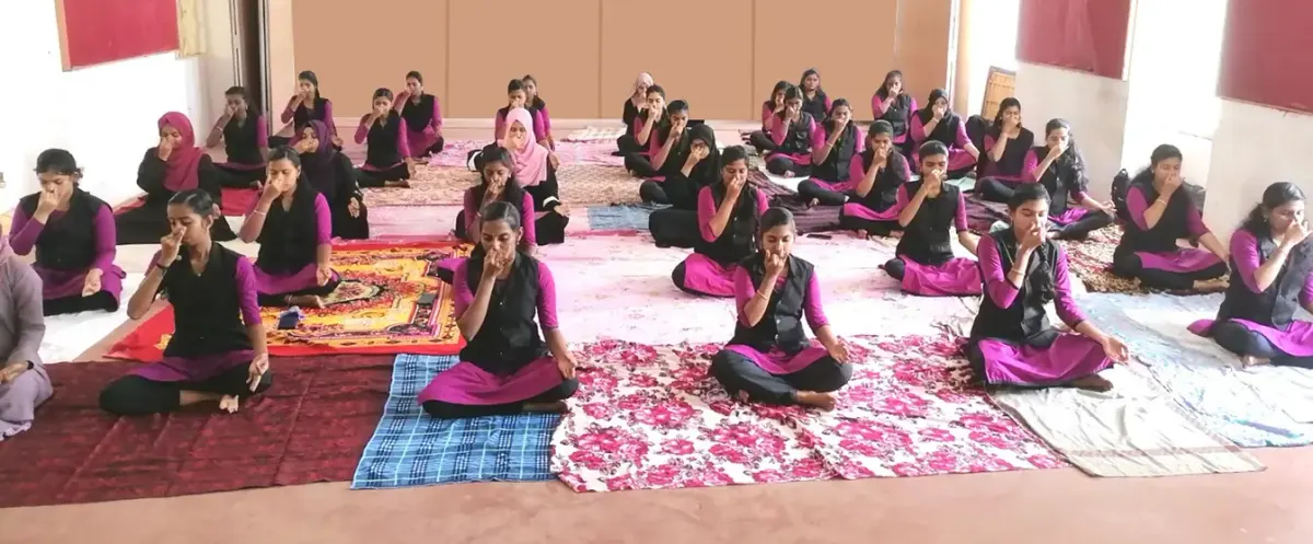 Students taking part in a group yoga and pranayama session